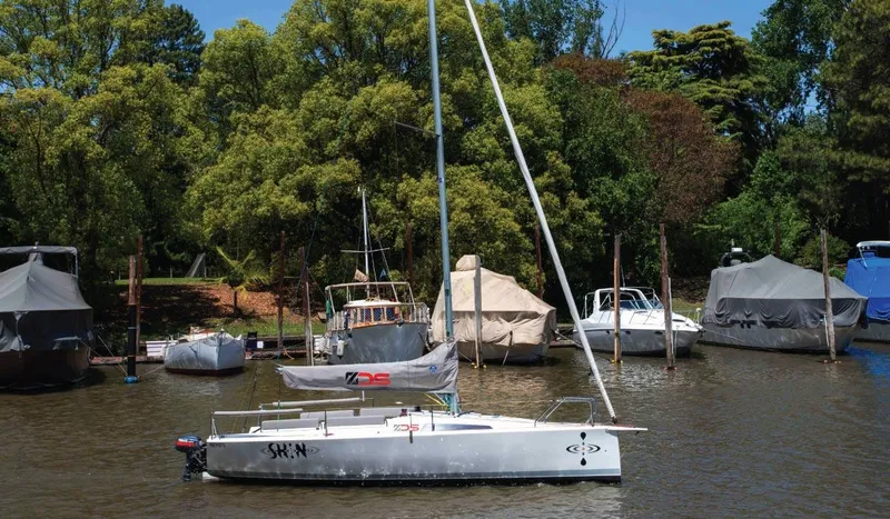 Slide: The Image of Sailboat Zonda Z24, 2024 model, docked in a serene marina with lush greenery. - 5