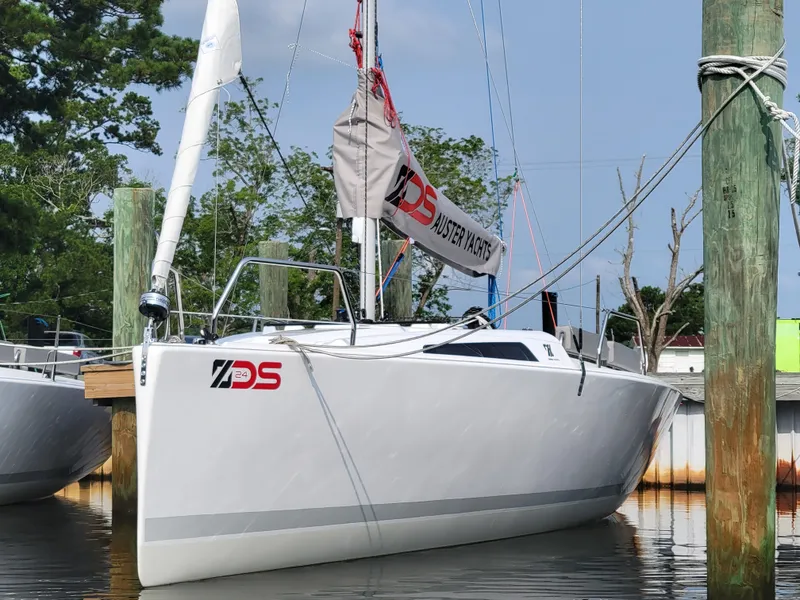 Slide: The Image of 2024 Zonda Z24 sailboat docked, featuring sleek design and modern rigging. - 6