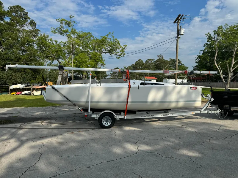 Slide: The Image of 2024 Zonda Z24 sailboat on trailer, parked outdoors under a clear sky. - 9