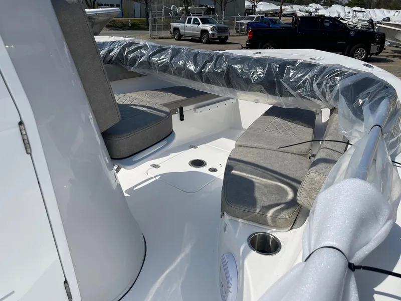 Slide: The Image of 2024 Sea Pro 202 Center Console boat interior with cushioned seating and clean white deck. - 4