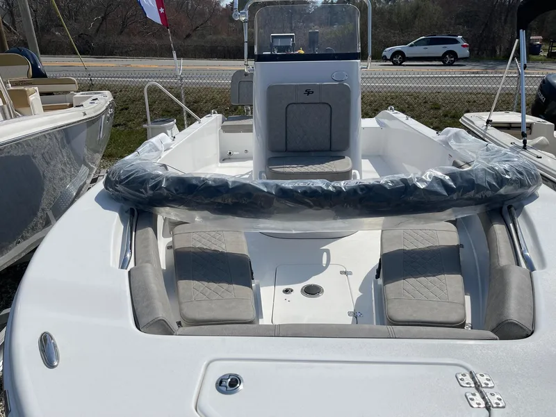 Slide: The Image of 2024 Sea Pro 202 Center Console boat with cushioned seating and modern design. - 6
