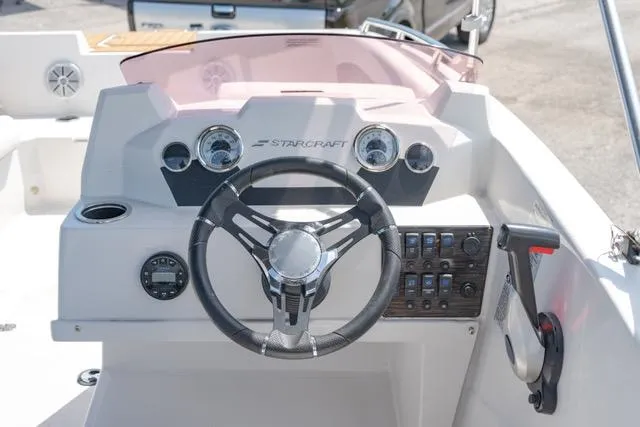 Slide: The Image of 2022 Starcraft SVX 171 OB boat dashboard with steering wheel and control panel. - 13