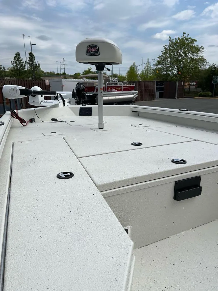 Slide: The Image of 2024 Ranger RB210 boat deck with storage compartments and mounted equipment under a cloudy sky. - 2