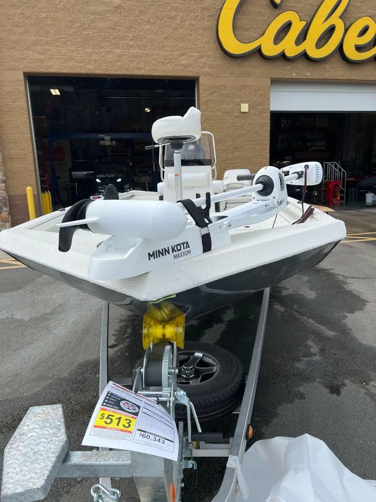 Slide: The Image of 2024 Ranger RB210 boat with Minn Kota motor on trailer outside Cabela's store. - 3