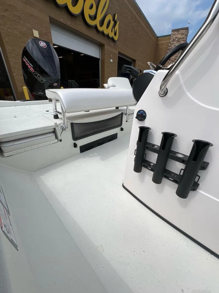 Slide: The Image of 2024 Ranger RB210 boat at Cabela's, featuring rod holders and a sleek white design. - 4