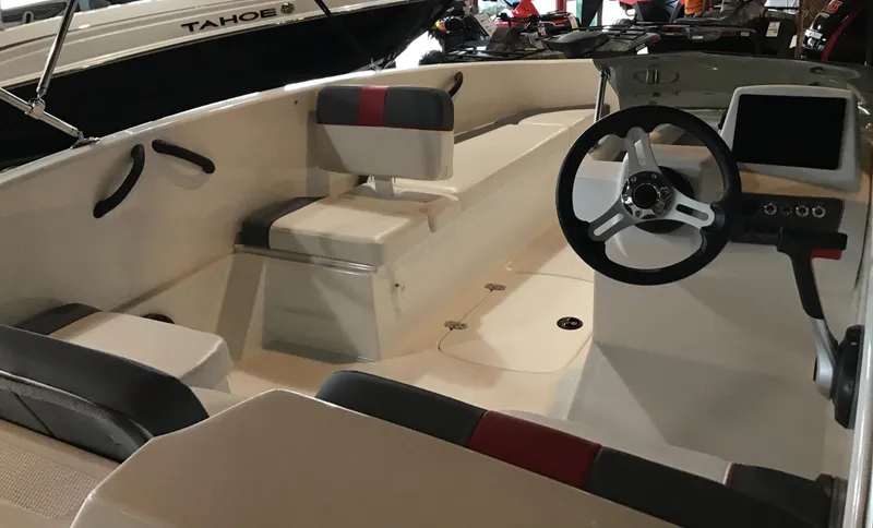 Slide: The Image of 2024 Tahoe T16 boat interior with steering wheel and seating. - 2