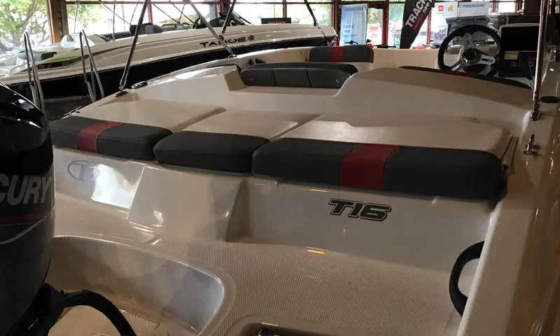 Slide: The Image of 2024 Tahoe T16 boat interior with cushioned seating and steering wheel. - 3