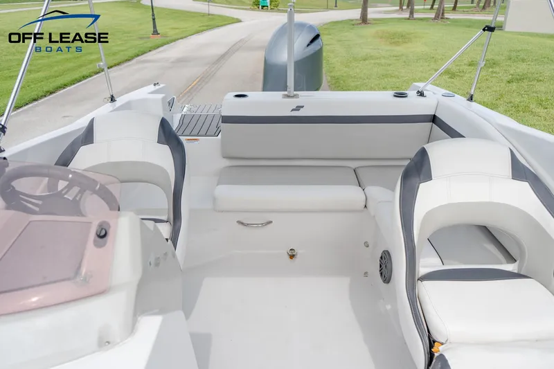 Slide: The Image of 2022 Starcraft SVX 231 OB boat interior with white and gray seating. - 14