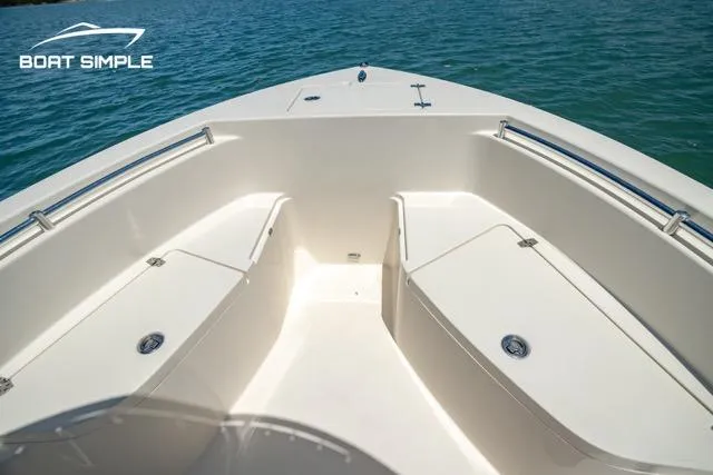 Slide: The Image of 2021 Cobia 201 Center Console boat interior with seating, on calm water. - 4