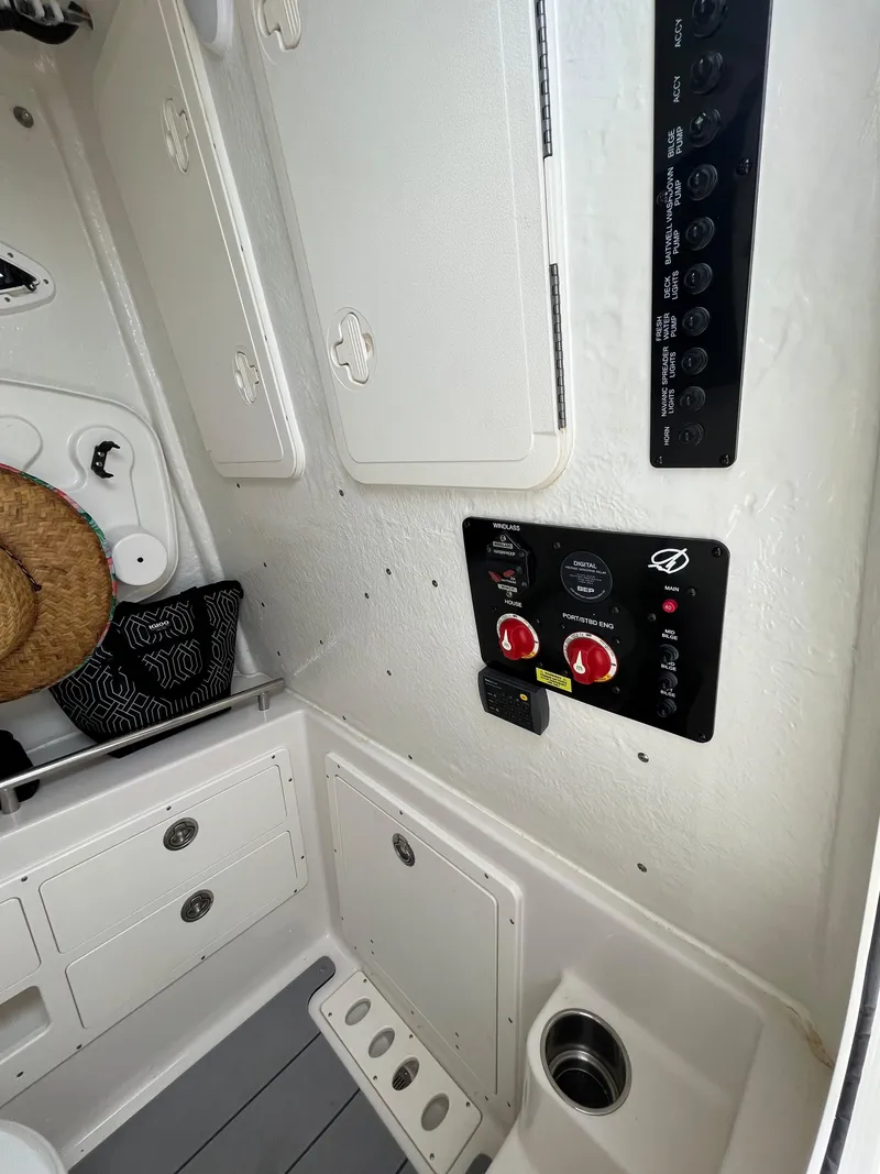 Slide: The Image of 2023 Sailfish 290 CC control panel and storage compartments. - 10