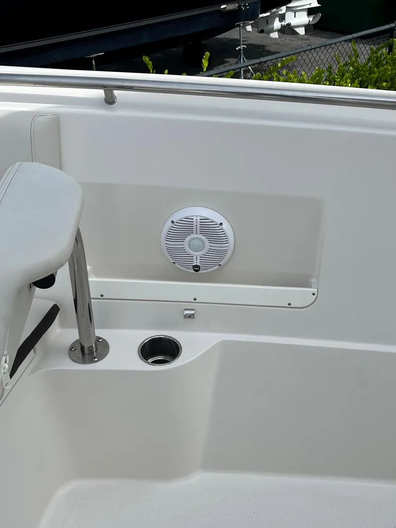 Slide: The Image of 2023 Sailfish 290 CC boat interior with speaker and cup holder. - 16