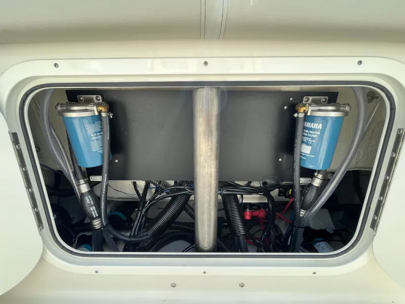 Slide: The Image of Engine compartment of 2023 Sailfish 290 CC boat showing dual Yamaha fuel filters. - 18