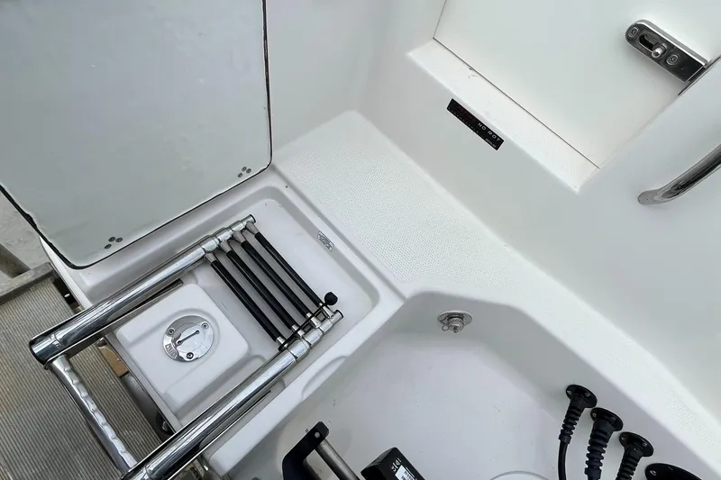 Slide: The Image of Sailfish 290 CC 2023 model boat interior with ladder and storage compartments. - 20