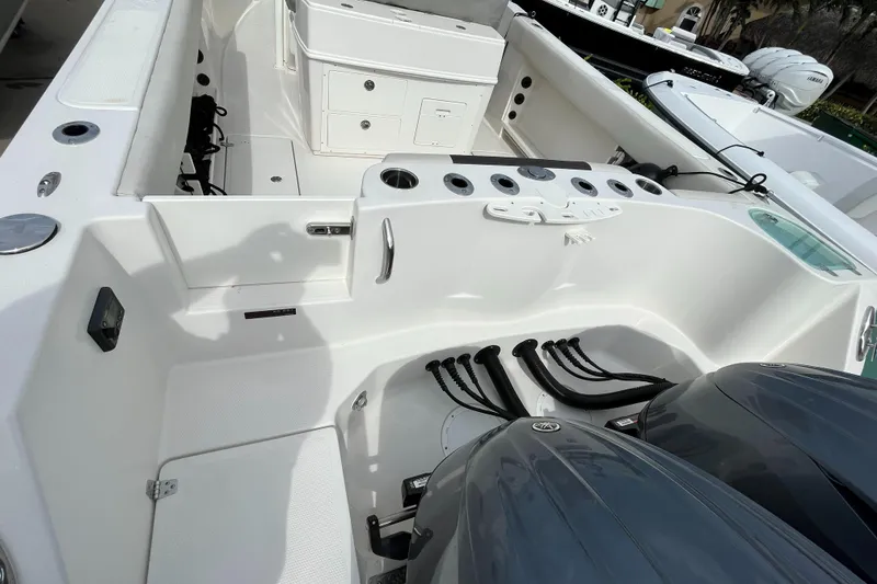 Slide: The Image of 2023 Sailfish 290 CC boat interior with dual outboard motors. - 22