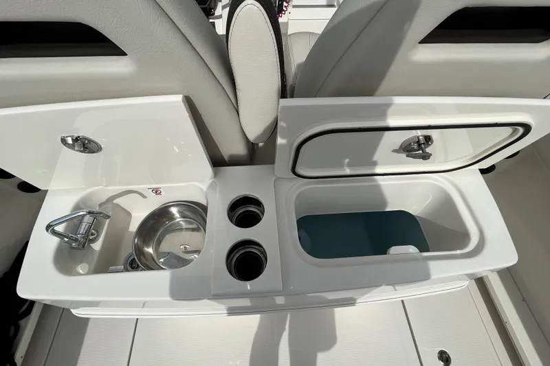Slide: The Image of 2023 Sailfish 290 CC boat interior with sink and storage compartments. - 23