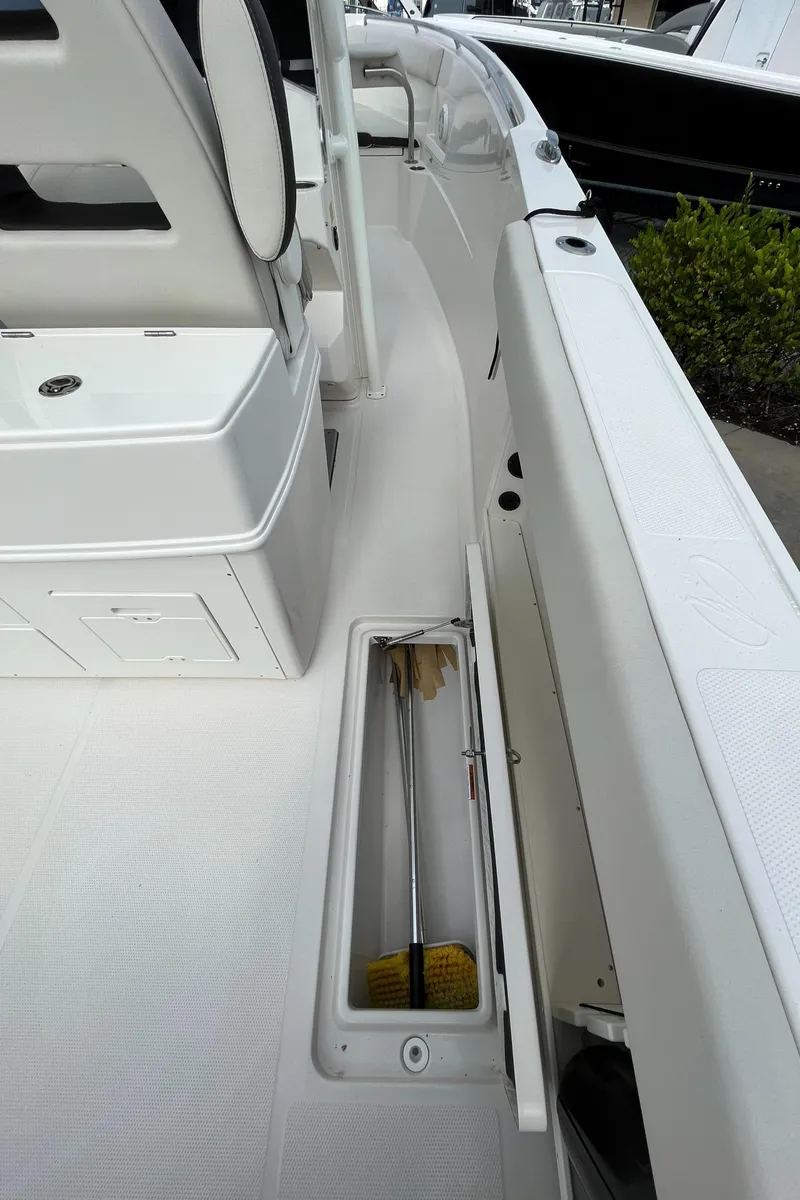 Slide: The Image of 2023 Sailfish 290 CC boat deck with storage compartment. - 25