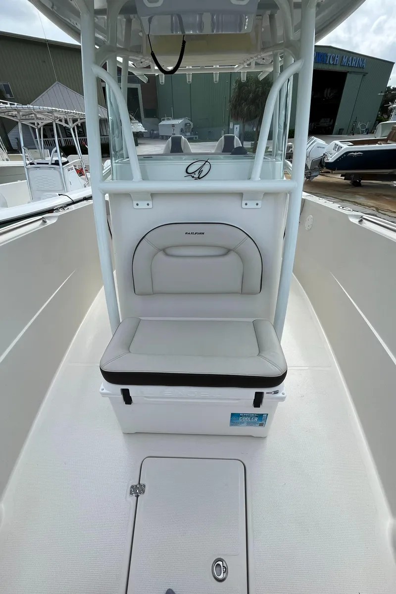 Slide: The Image of 2023 Sailfish 290 CC center console boat interior with cushioned seating. - 26