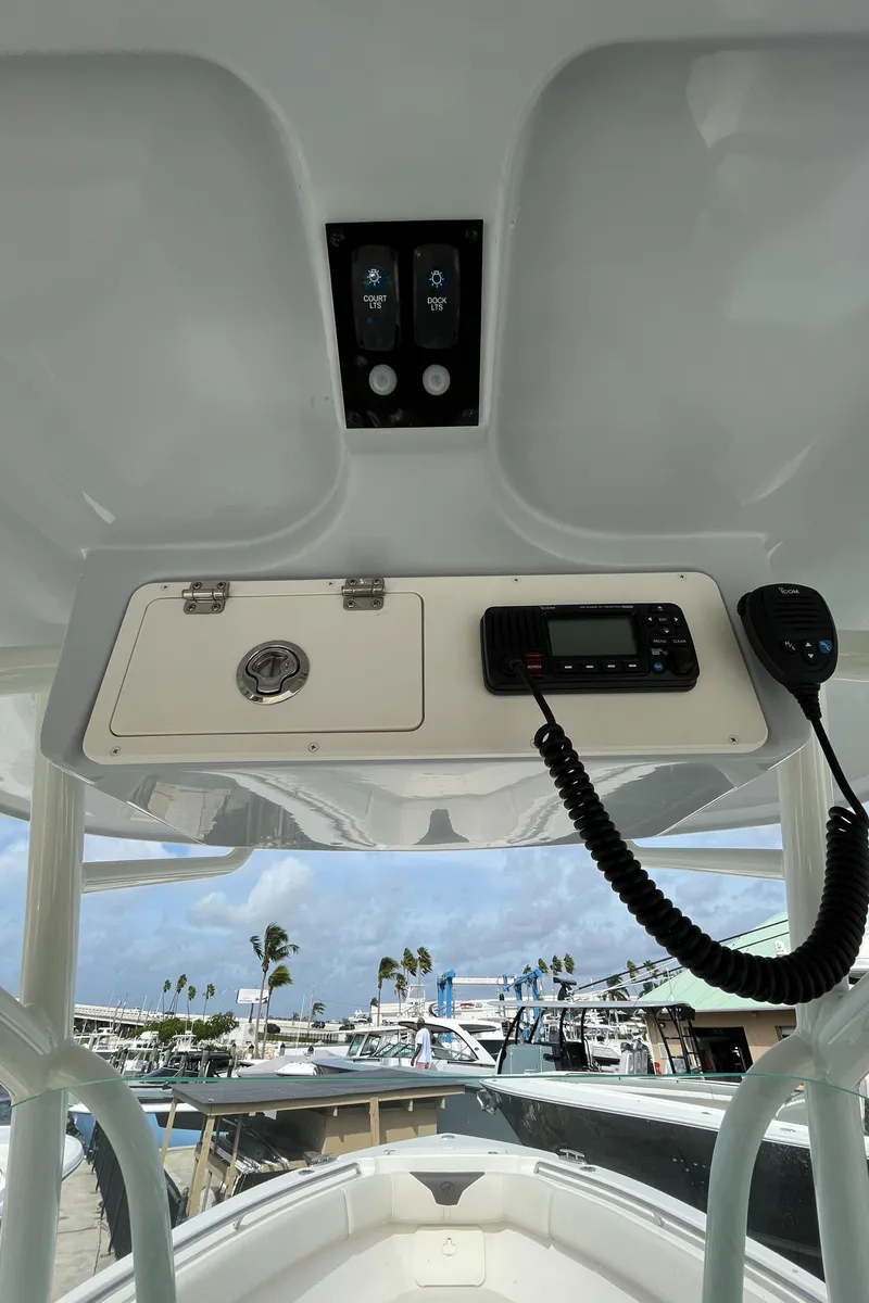 Slide: The Image of 2023 Sailfish 290 CC boat console with radio and control panel. - 30