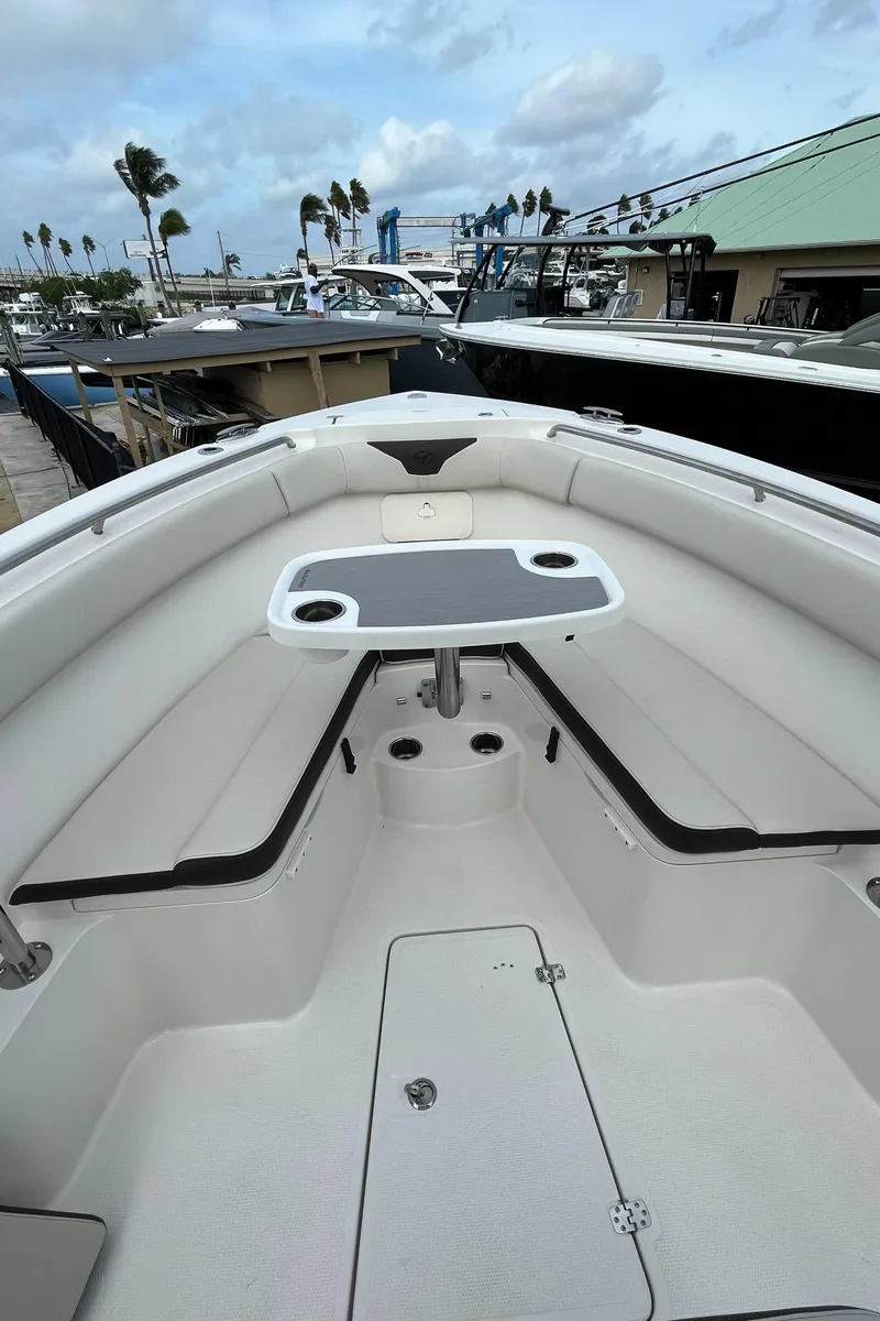Slide: The Image of 2023 Sailfish 290 CC boat interior with seating and table. - 32