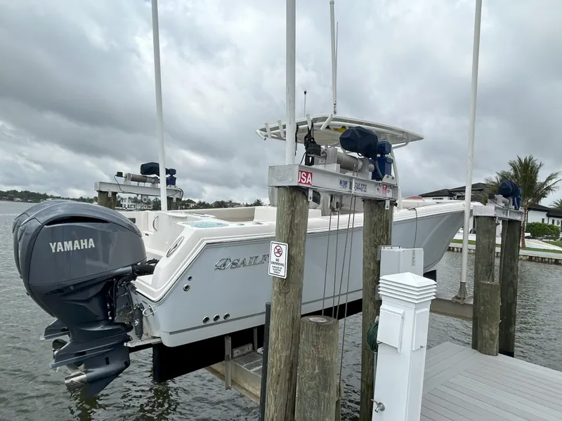 Slide: The Image of 2023 Sailfish 290 CC boat with Yamaha engine docked at marina. - 35