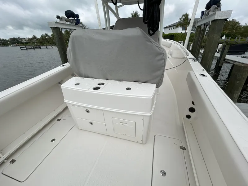 Slide: The Image of 2023 Sailfish 290 CC boat interior with covered seating and storage compartments. - 38