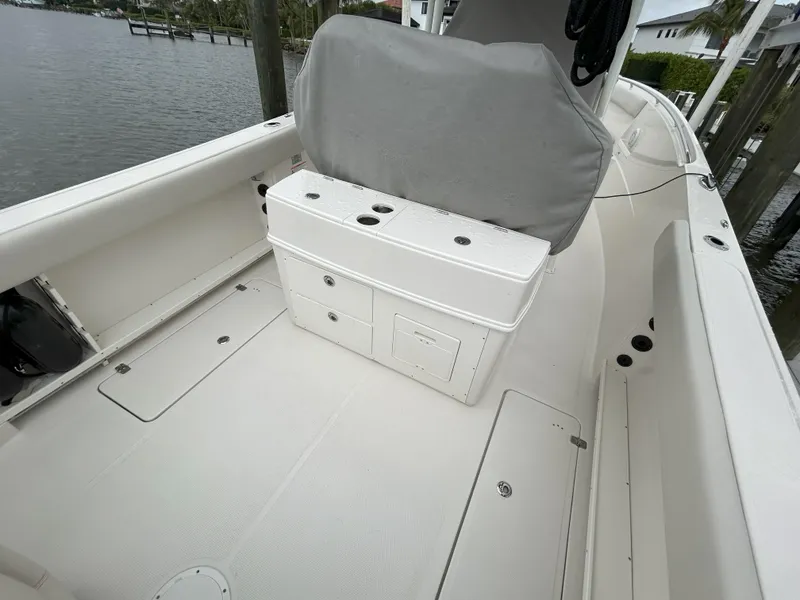 Slide: The Image of 2023 Sailfish 290 CC boat interior with storage compartments and seating. - 39