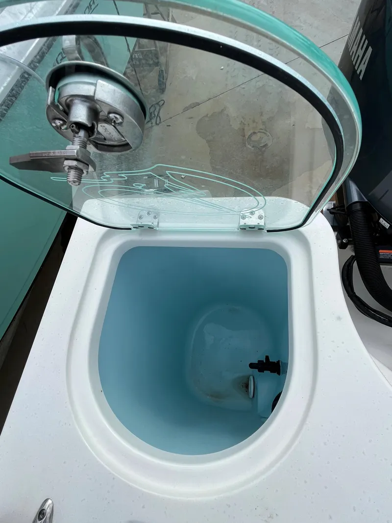 Slide: The Image of Livewell compartment on a 2023 Sailfish 290 CC boat with open glass lid. - 4