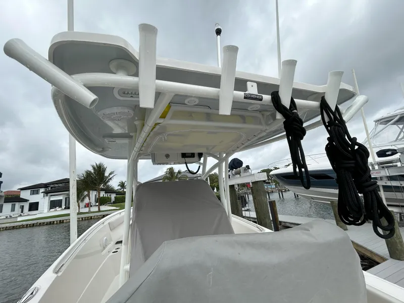 Slide: The Image of 2023 Sailfish 290 CC boat docked, featuring rod holders and covered console. - 41
