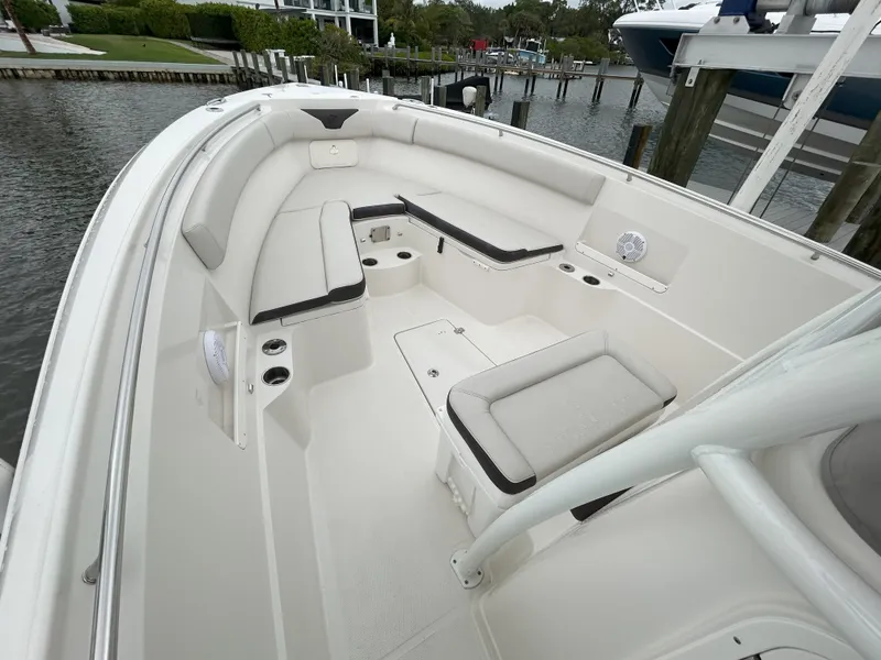 Slide: The Image of 2023 Sailfish 290 CC boat interior with cushioned seating and storage compartments. - 42
