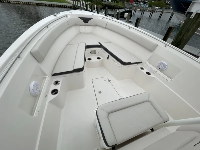 Slide: The Image of 2023 Sailfish 290 CC boat interior with white seating and cup holders. - 43