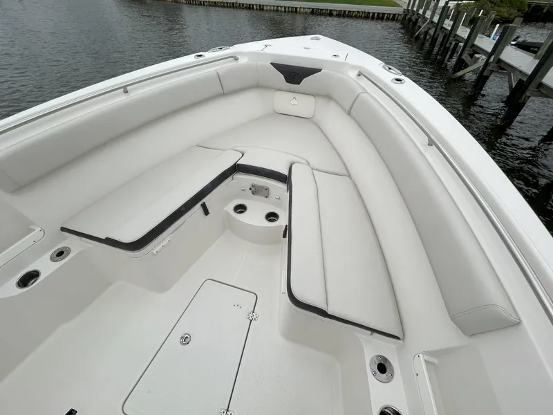 Slide: The Image of 2023 Sailfish 290 CC boat interior with white cushioned seating. - 45