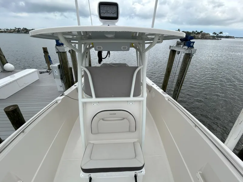 Slide: The Image of 2023 Sailfish 290 CC center console boat docked by the water. - 47