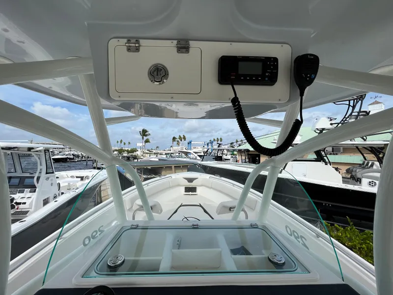 Slide: The Image of 2023 Sailfish 290 CC boat dashboard and bow view at marina. - 6