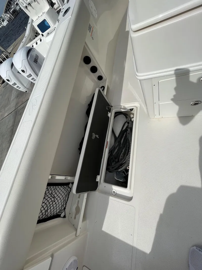 Slide: The Image of 2023 Sailfish 290 CC boat storage compartment with coiled cables. - 7