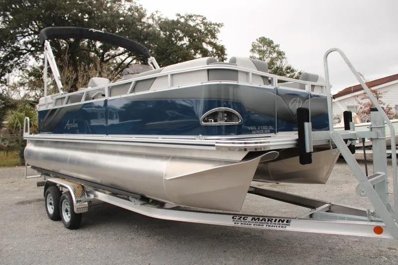Slide: The Image of 2024 Avalon VENTURE QUAD LOUNGER pontoon boat on trailer. - 2