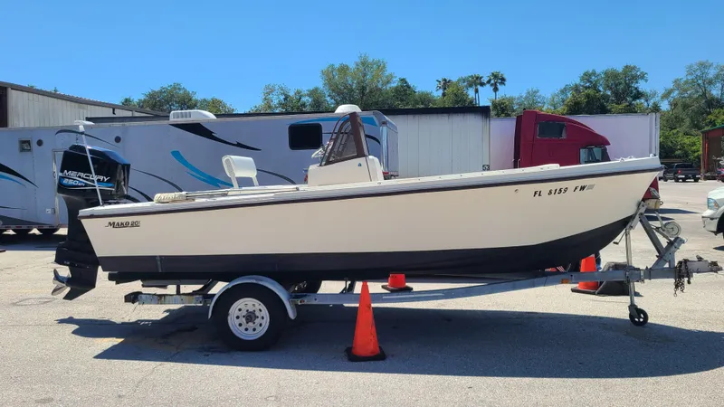 The Image of 1988 Mako 20 Center Console boat on trailer in parking lot. - 0