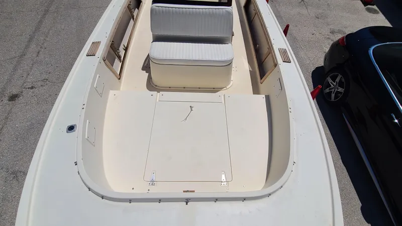 Slide: The Image of 1988 Mako 20 Center Console boat interior with seating and storage compartments. - 10