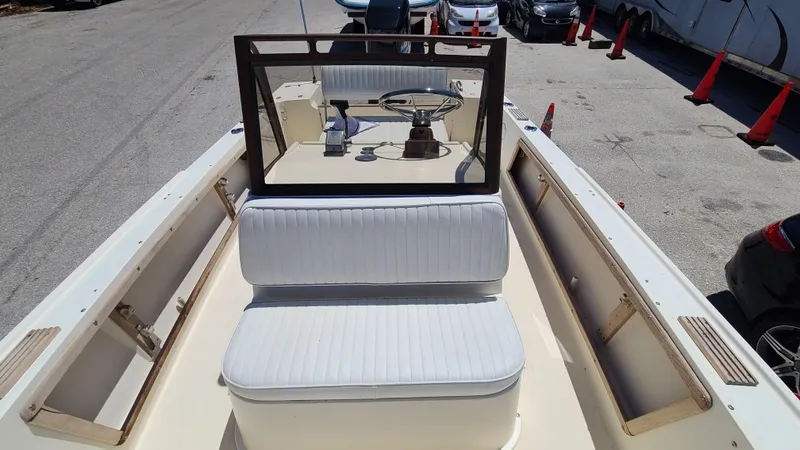 Slide: The Image of 1988 Mako 20 Center Console boat with white seating and steering console. - 12