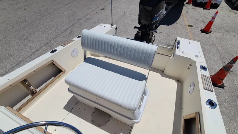 Slide: The Image of 1988 Mako 20 Center Console boat interior with white cushioned seating. - 18