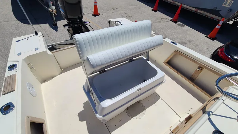 Slide: The Image of 1988 Mako 20 Center Console boat interior with bench seat and storage. - 19