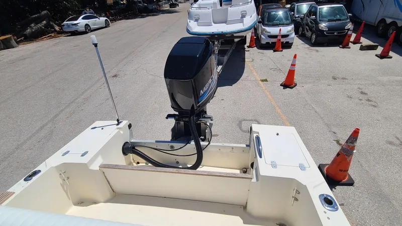 Slide: The Image of 1988 Mako 20 Center Console boat with outboard motor in a parking lot. - 20