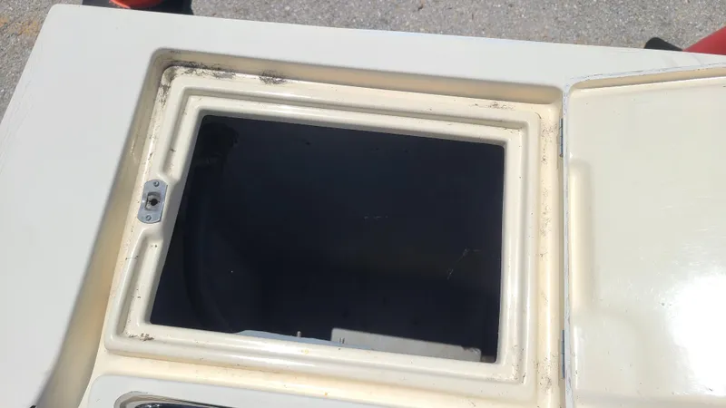 Slide: The Image of Open storage compartment on a 1988 Mako 20 Center Console boat. - 23