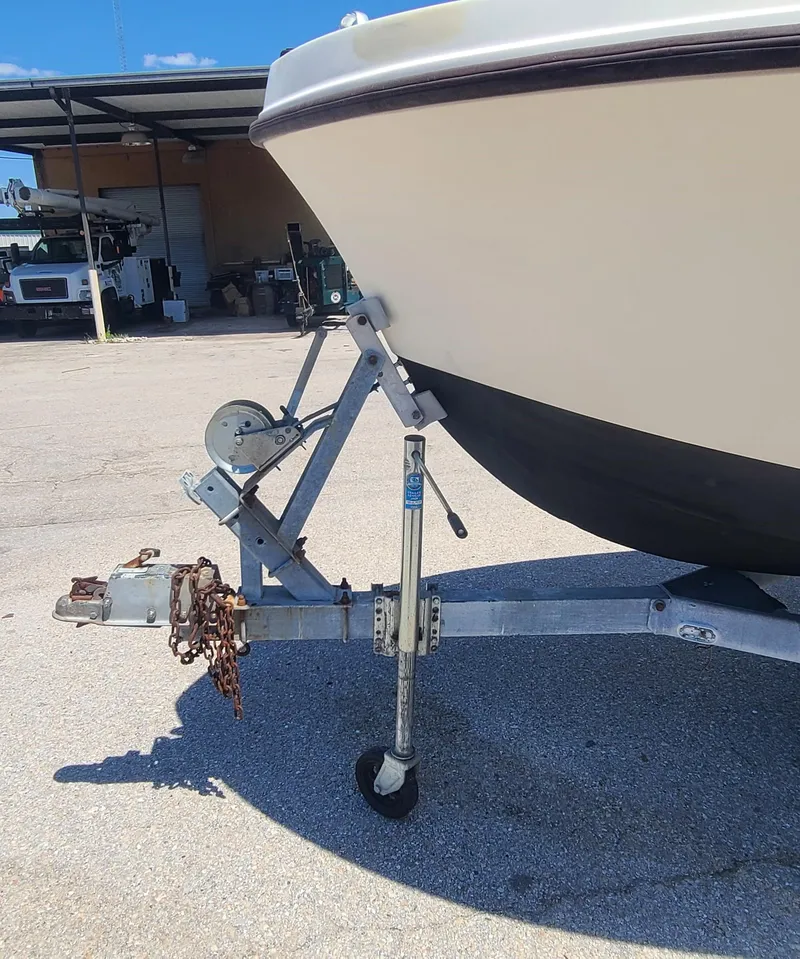 Slide: The Image of 1988 Mako 20 Center Console boat on a trailer in a parking lot. - 31