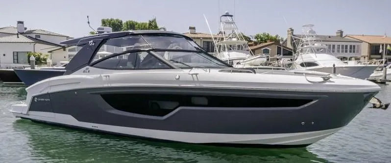 Slide: The Image of 2023 Cruisers Yachts 38 GLS OB luxury boat docked in a marina. - 0