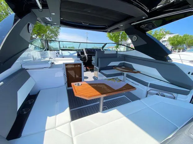 Slide: The Image of 2023 Cruisers Yachts 38 GLS OB interior with luxurious seating and modern amenities. - 11