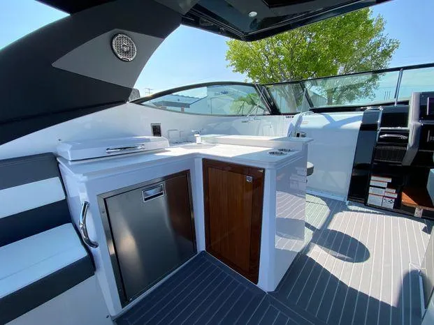 Slide: The Image of 2023 Cruisers Yachts 38 GLS OB interior with kitchenette and seating area. - 12