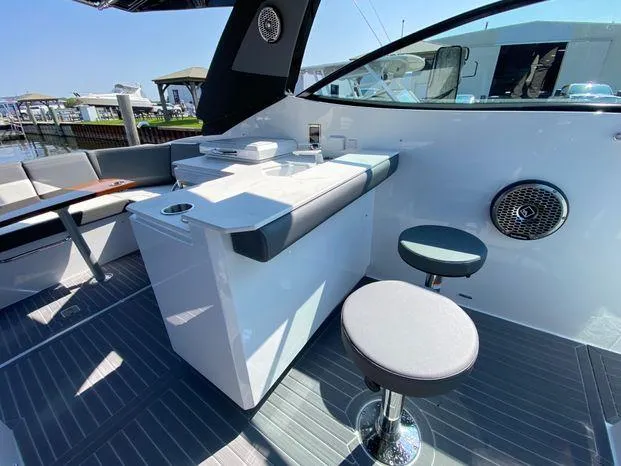 Slide: The Image of 2023 Cruisers Yachts 38 GLS OB interior with seating and table. - 14