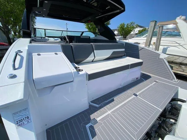 Slide: The Image of 2023 Cruisers Yachts 38 GLS OB, spacious deck with seating, modern design. - 16