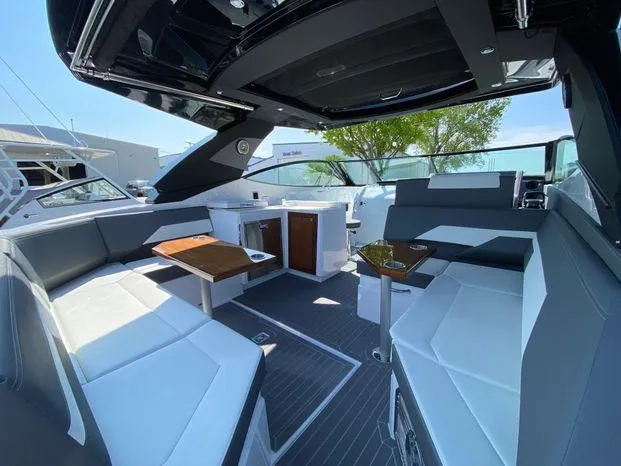 Slide: The Image of 2023 Cruisers Yachts 38 GLS OB interior with modern seating and dining area. - 17
