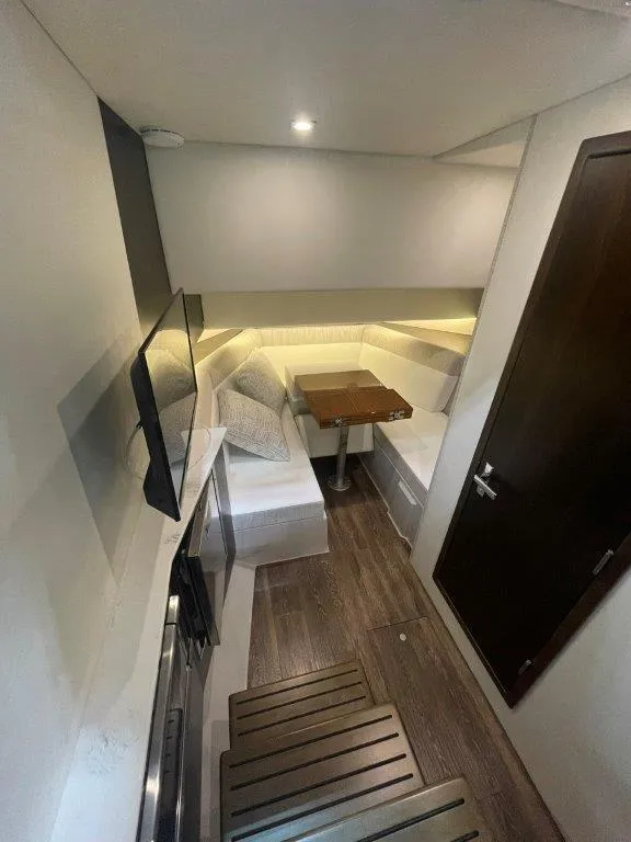 Slide: The Image of 2023 Cruisers Yachts 38 GLS OB interior cabin with modern furnishings and wooden flooring. - 20